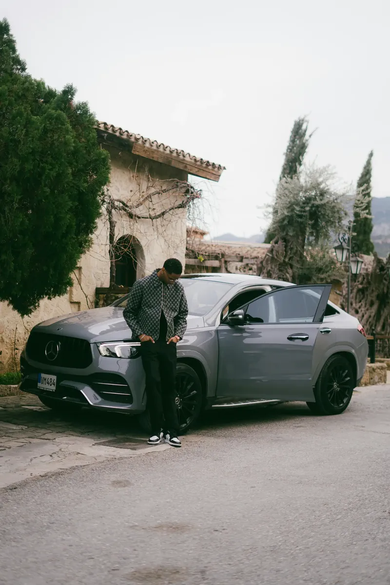 A man in an apron looking at a computer screen