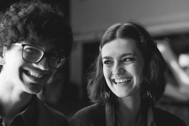Woman in orange tank top and blue denim jacket